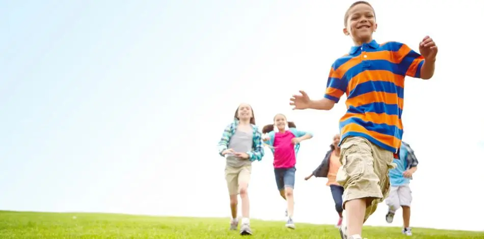 Dzieci skaczące na trawniku